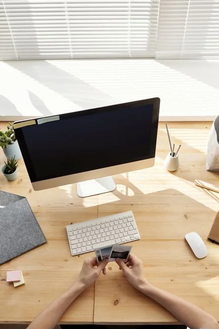 A stylish workspace featuring a laptop and monitors displaying design software.